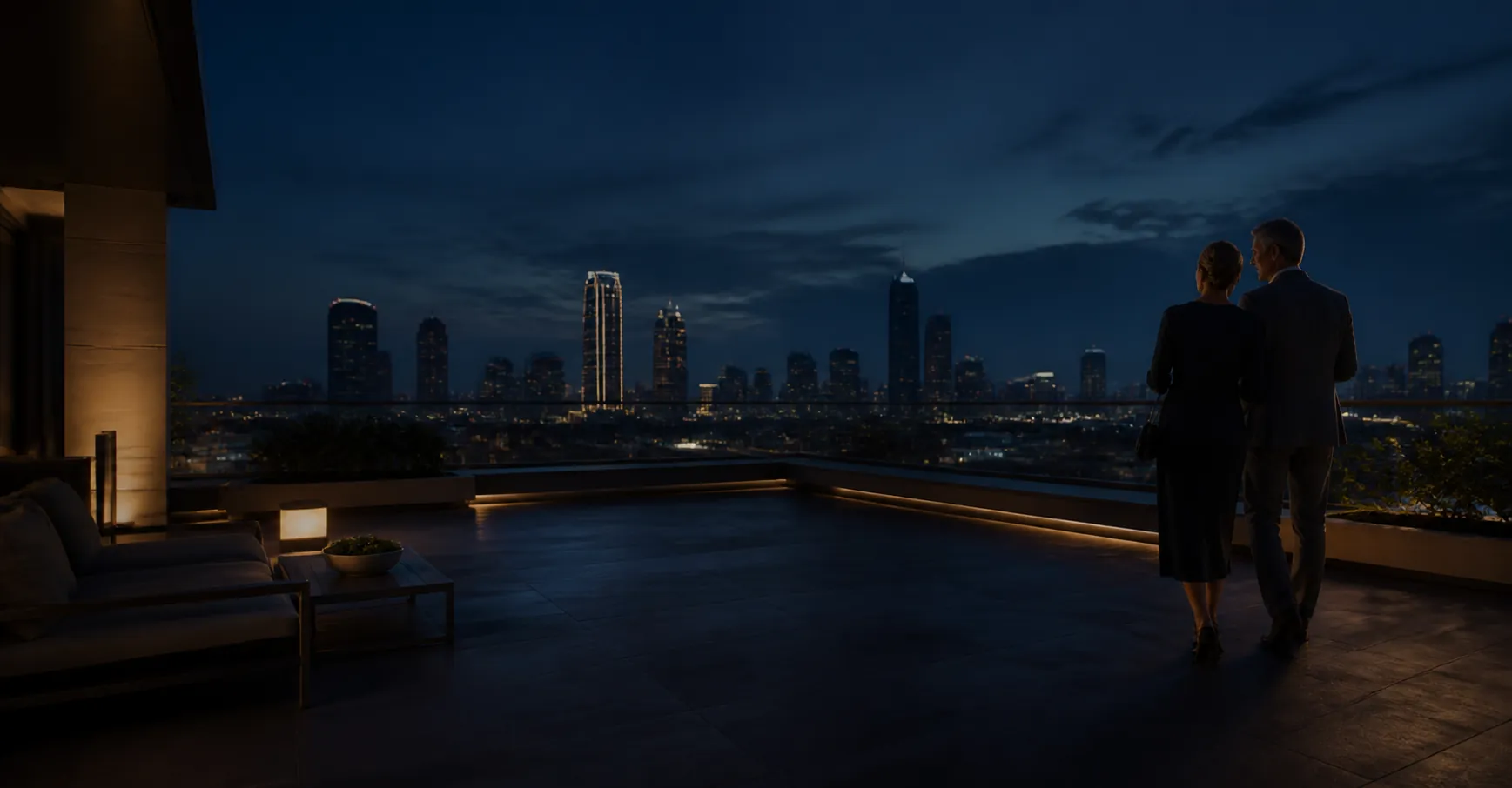 An elegant couple walking across a Dallas rooftop at night